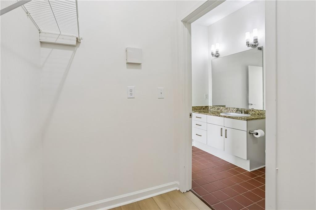 5300 Peachtree Road, Unit 3506 Atlanta, GA 30341 - Photo 12 of 25 a spacious bathroom with a granite countertop sink and a mirror