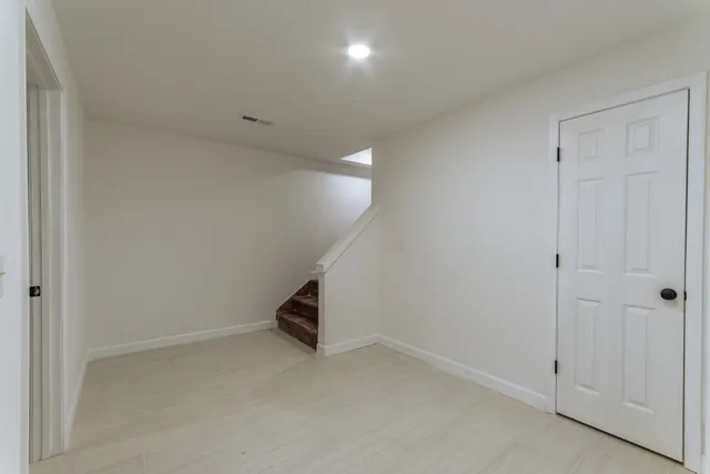 an empty room with windows and entrance