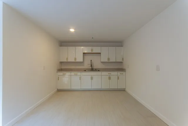 a kitchen with white cabinets
