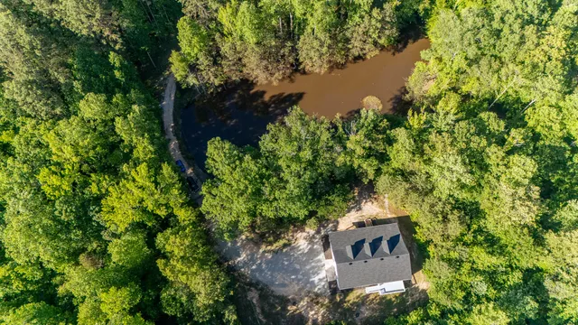 a view of a house with a yard and trees