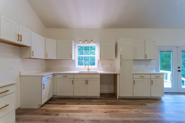 a kitchen with a sink cabinets and window