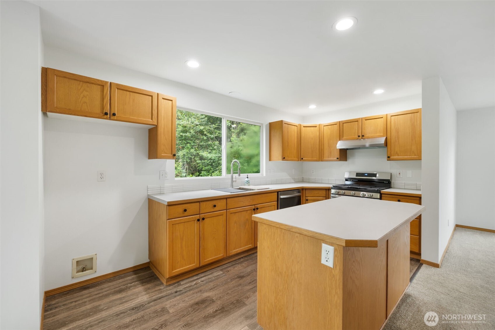 3560 Courtyard Lane Bremerton, WA 98310 - Photo 8 of 26 a kitchen with stainless steel appliances granite countertop a sink a stove and a refrigerator