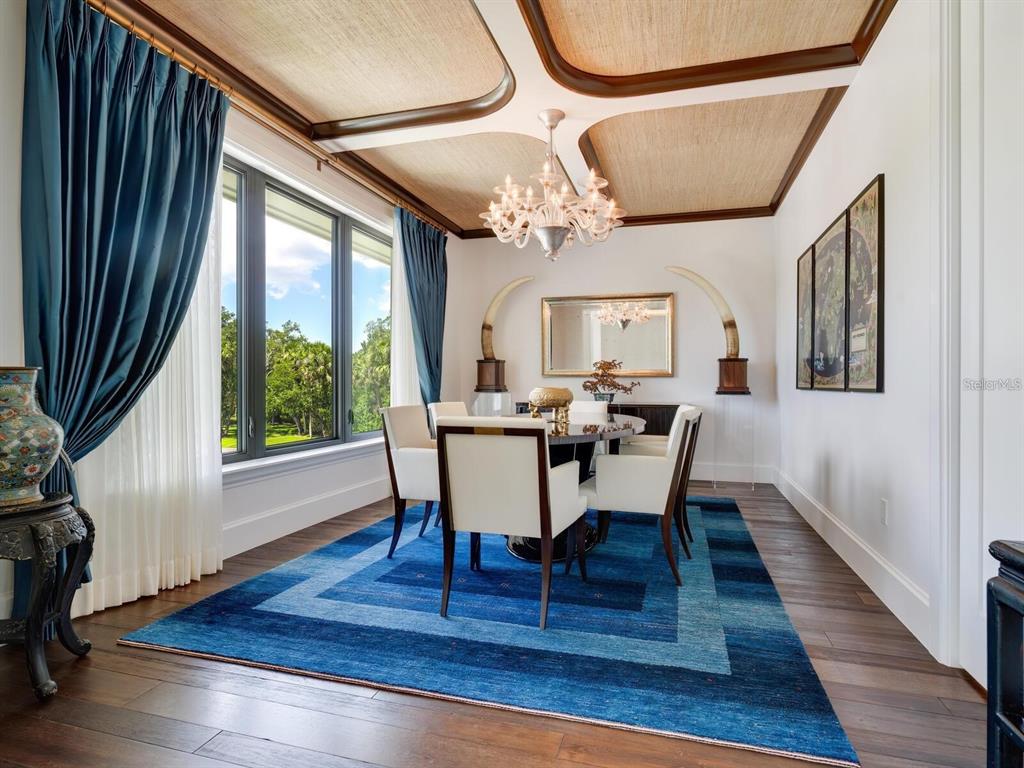 1245 Mill Creek Road Bradenton, FL 34212 - Photo 14 of 56 a view of a dining room with furniture a chandelier and wooden floor