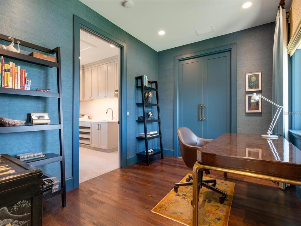 1245 Mill Creek Road Bradenton, FL 34212 - Photo 19 of 56 a view of a workspace with furniture and wooden floor