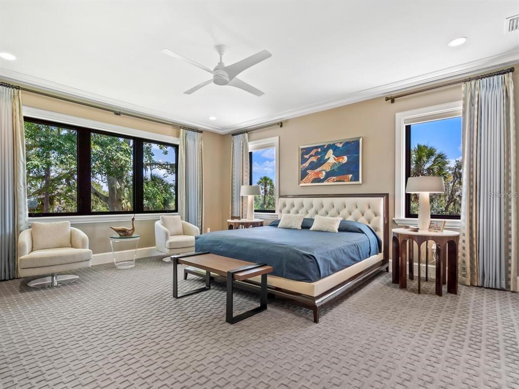 1245 Mill Creek Road Bradenton, FL 34212 - Photo 21 of 56 a spacious bedroom with a bed and a large window