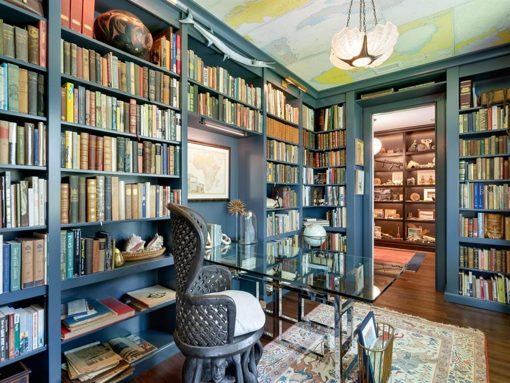 1245 Mill Creek Road Bradenton, FL 34212 - Photo 25 of 56 a living room with lots of books and a book shelf
