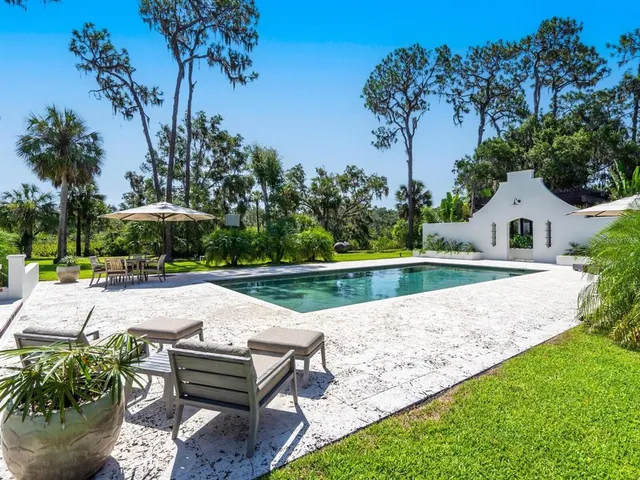 a view of house with yard and sitting area