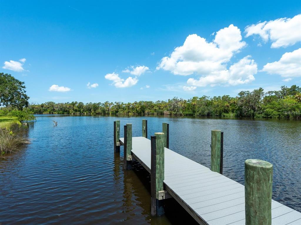 1245 Mill Creek Road Bradenton, FL 34212 - Photo 38 of 56 a view of a lake with couches chairs