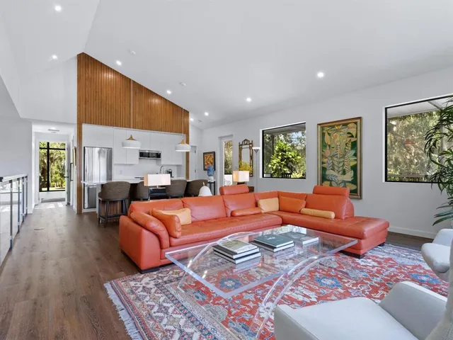 a living room with lots of furniture and clutter