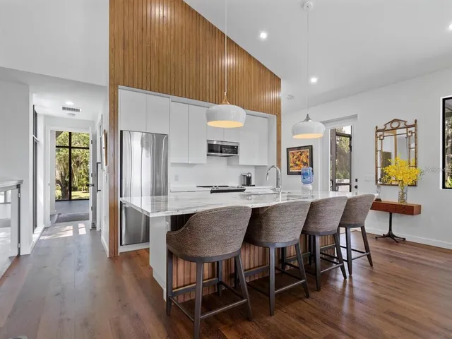 a living room with furniture a rug and paintings on wall