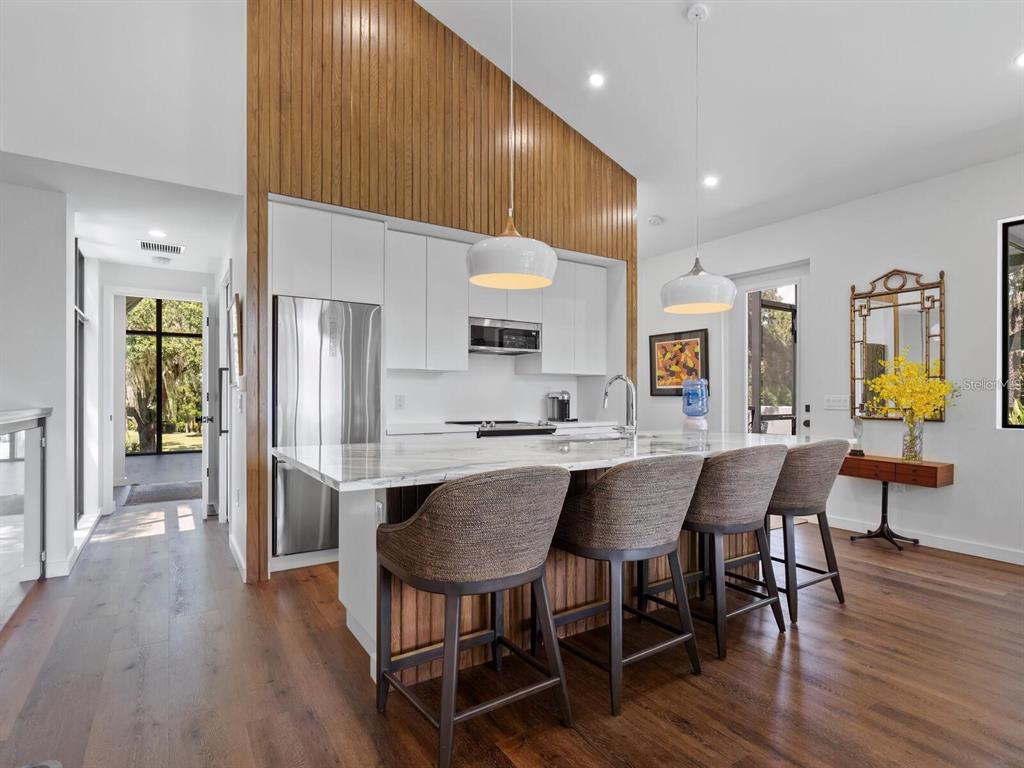 1245 Mill Creek Road Bradenton, FL 34212 - Photo 42 of 56 a view of a dining room with furniture and wooden floor
