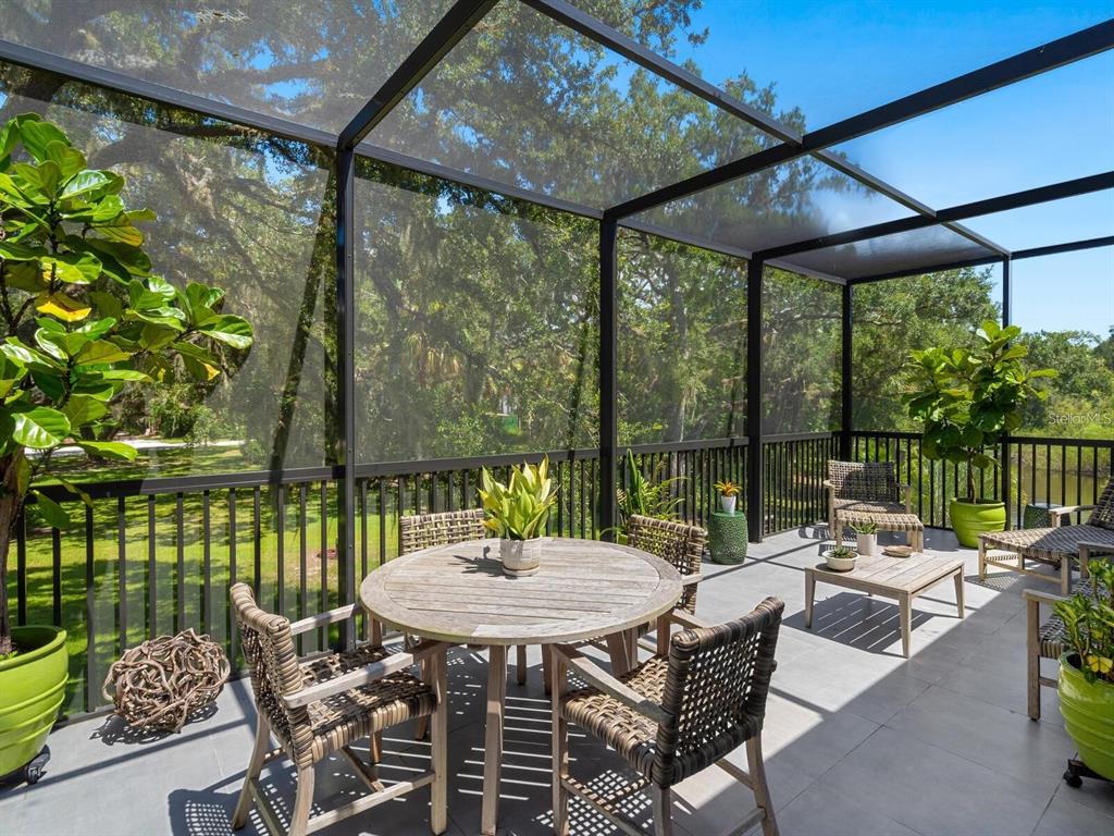 1245 Mill Creek Road Bradenton, FL 34212 - Photo 44 of 56 a view of a patio with a table chairs and a table