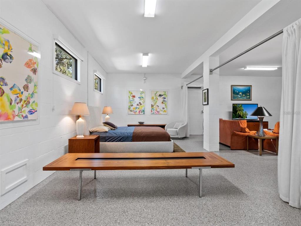 1245 Mill Creek Road Bradenton, FL 34212 - Photo 46 of 56 a living room with furniture a rug and paintings on wall