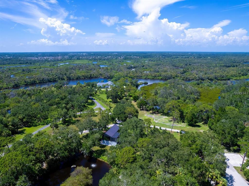 1245 Mill Creek Road Bradenton, FL 34212 - Photo 7 of 56 a view of a city with lush green forest