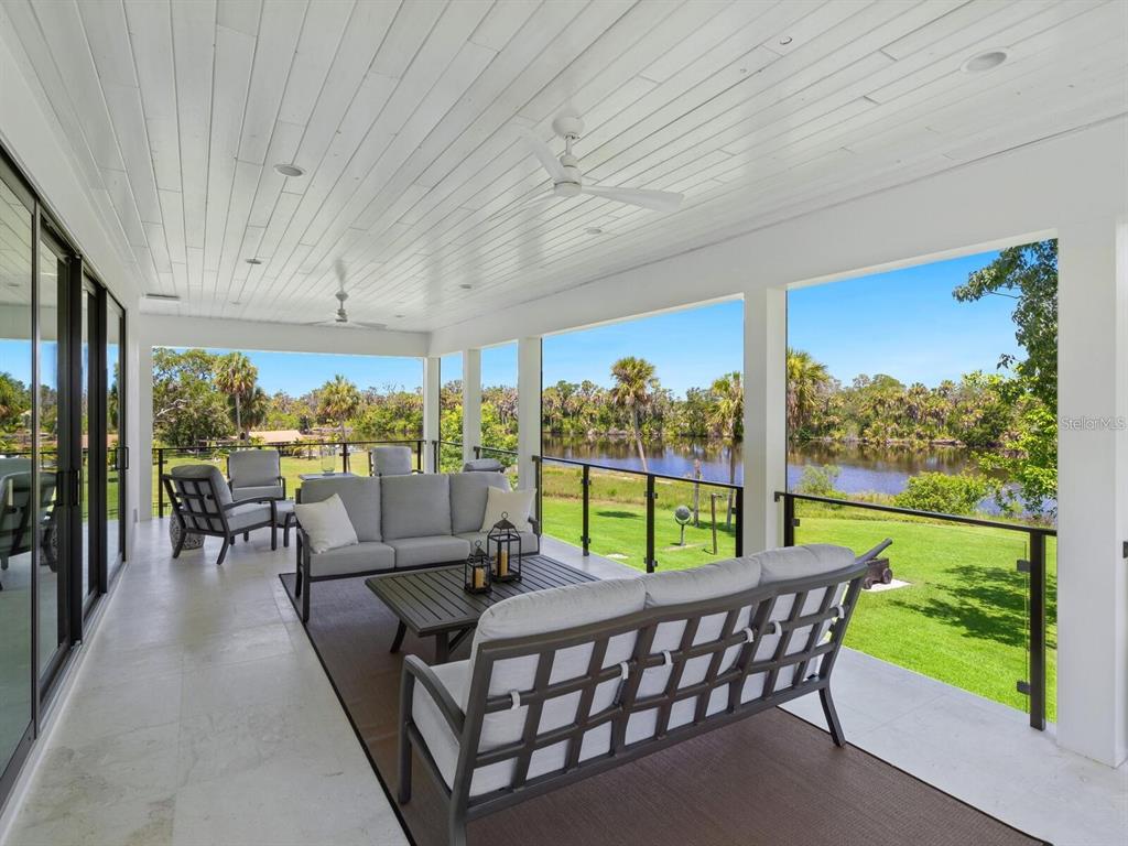 1245 Mill Creek Road Bradenton, FL 34212 - Photo 10 of 56 an outdoor living area with furniture and garden view