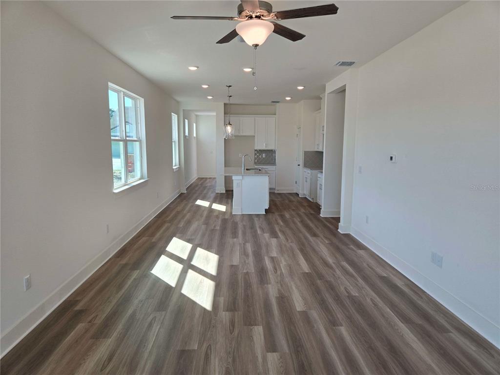 3841 Daybreak Run Loop Spring Hill, FL 34609 - Photo 4 of 11 a view of a living room hardwood floor and a kitchen