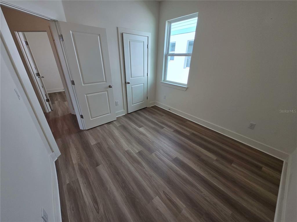 3841 Daybreak Run Loop Spring Hill, FL 34609 - Photo 8 of 11 a view of an empty room with wooden floor and a window