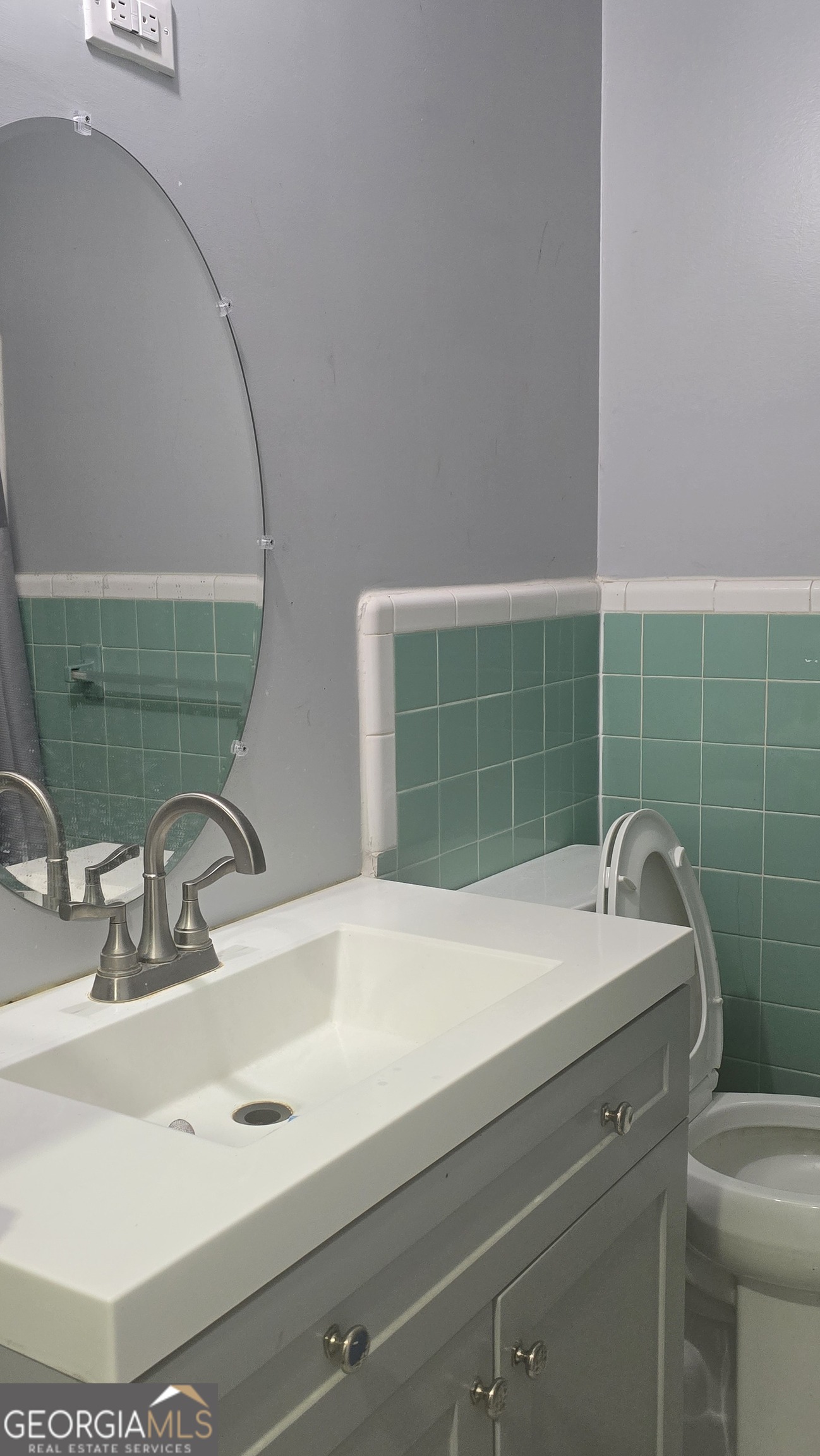 6359 Lanier Road Morrow, GA 30260 - Photo 12 of 15 a bathroom with a sink and a mirror