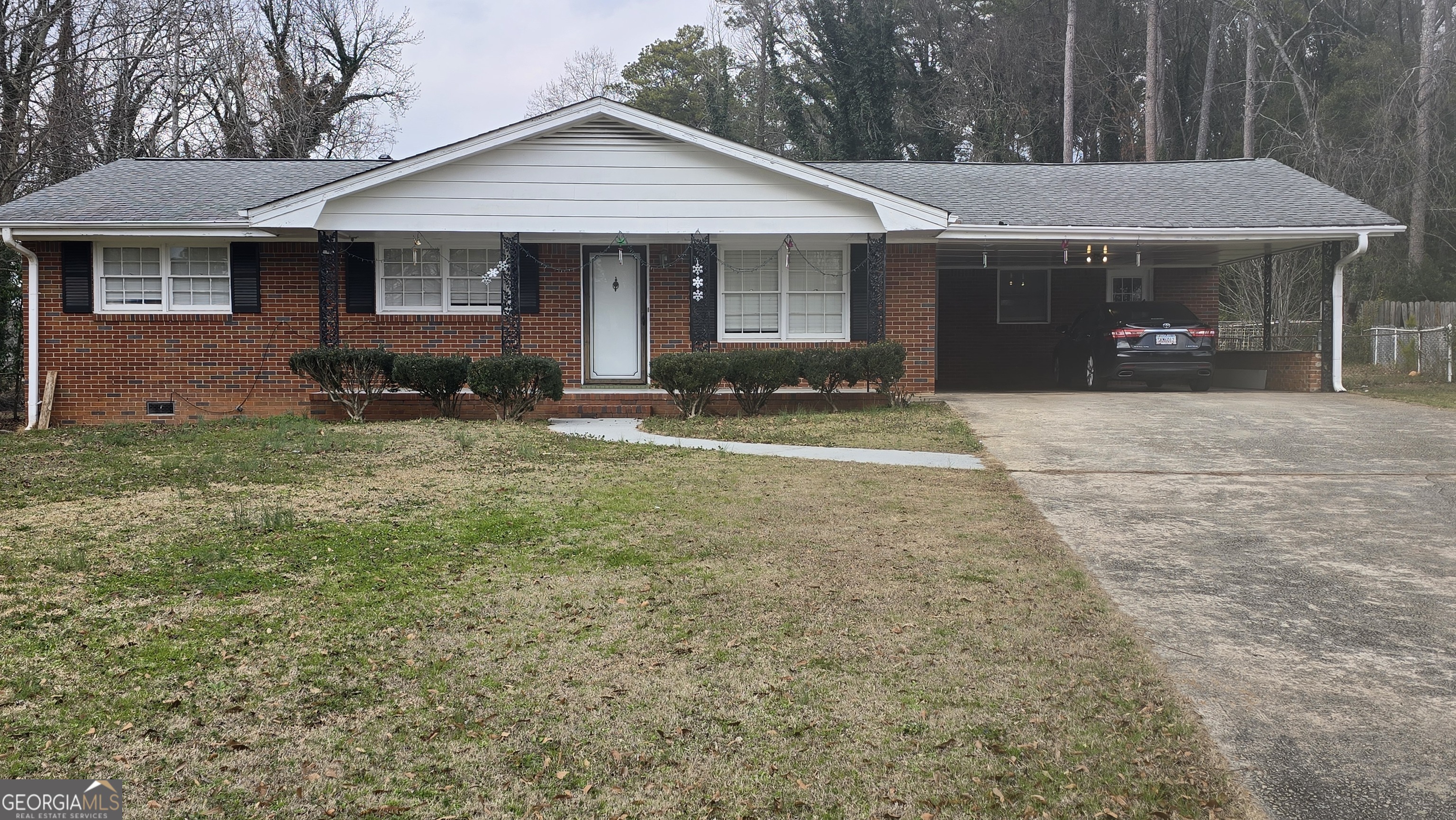 6359 Lanier Road Morrow, GA 30260 - Photo 2 of 15 a front view of a house with a yard and garage