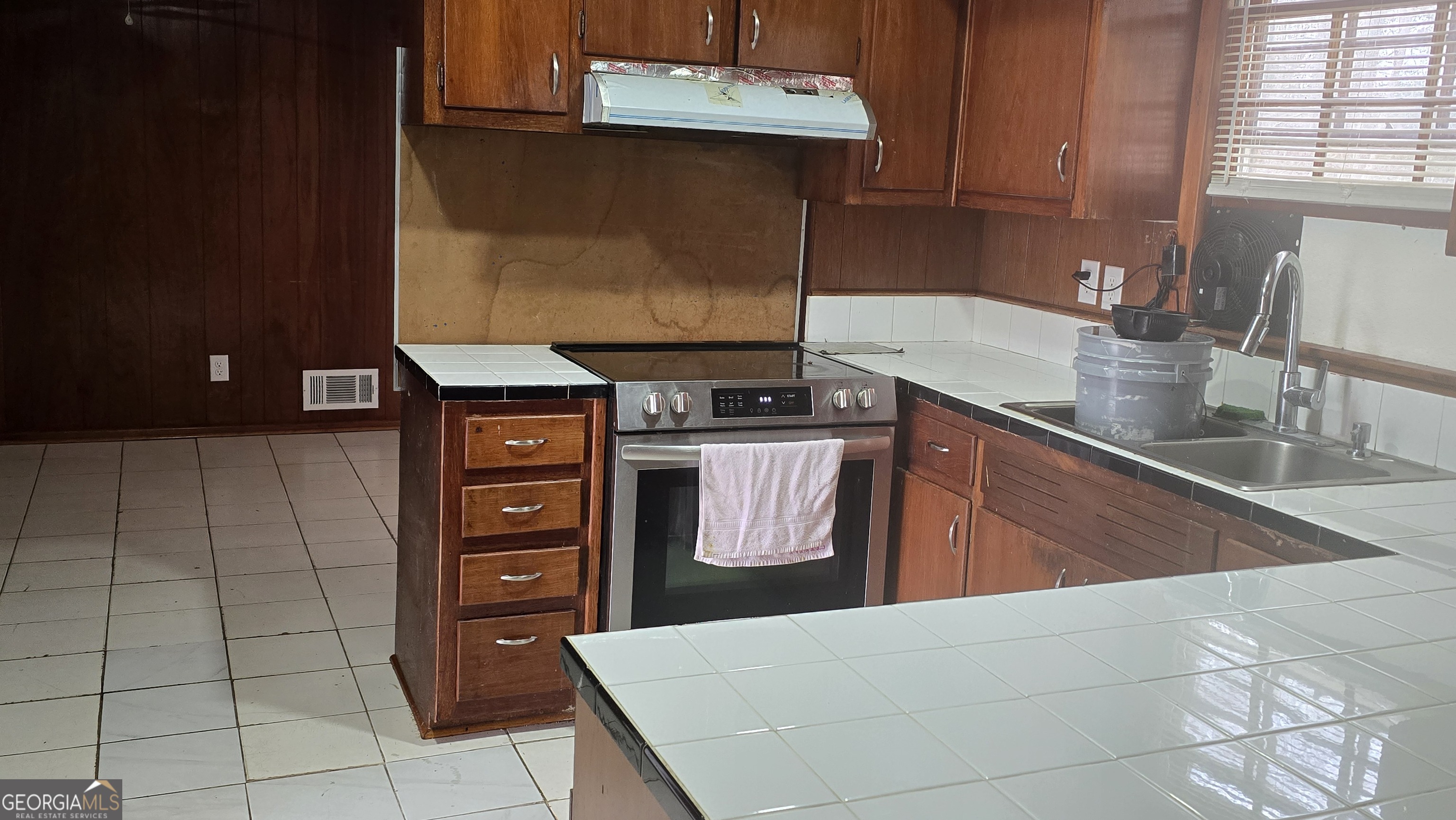 6359 Lanier Road Morrow, GA 30260 - Photo 6 of 15 a kitchen with stainless steel appliances a stove a sink and a microwave