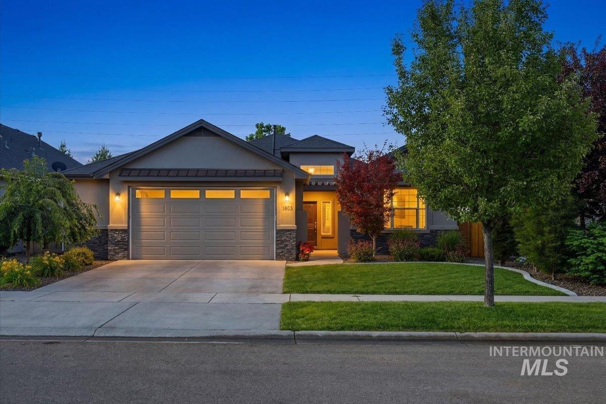 Contemporary single-story residence with a two-car garage and stone accents