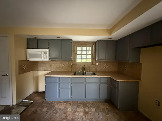 a kitchen with a sink and cabinets