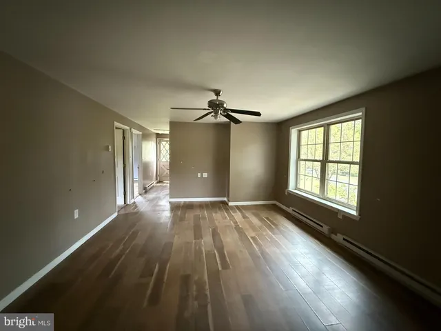 wooden floor in an empty room with a window