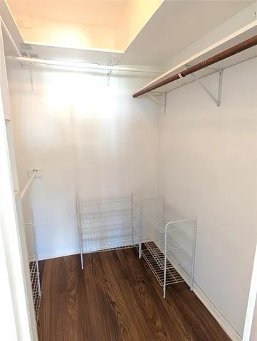 a view of a room with wooden floor and a window