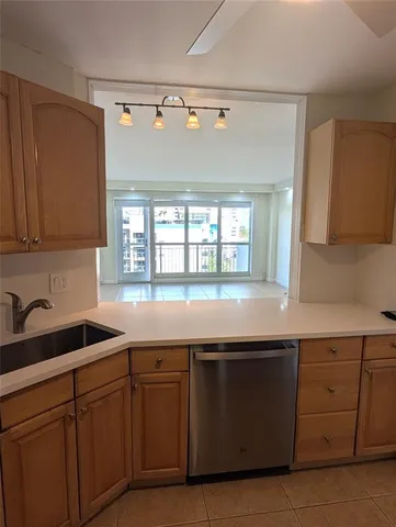 a kitchen with granite countertop a sink and cabinets