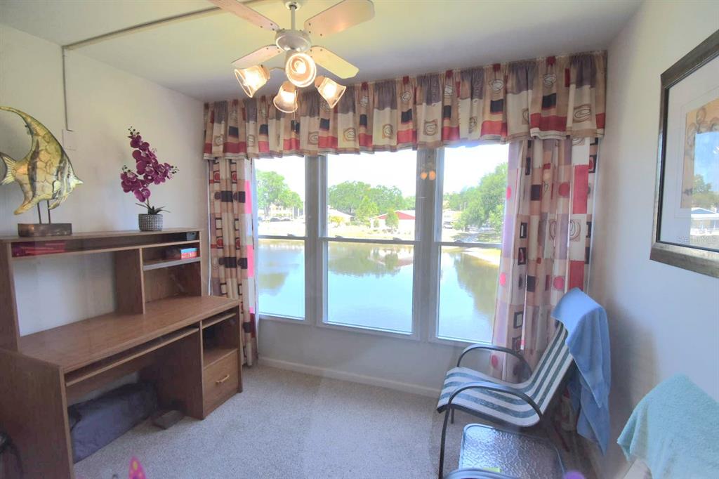 936 Virginia Street, Unit 206 Dunedin, FL 34698 - Photo 14 of 22 a room with furniture and a large window