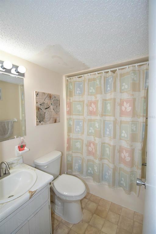 936 Virginia Street, Unit 206 Dunedin, FL 34698 - Photo 17 of 22 a bathroom with a sink toilet and shower