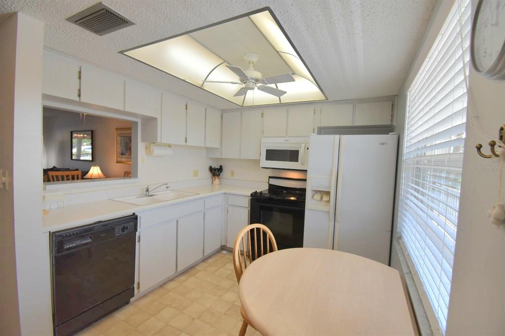936 Virginia Street, Unit 206 Dunedin, FL 34698 - Photo 19 of 22 a kitchen with stainless steel appliances a refrigerator sink and stove