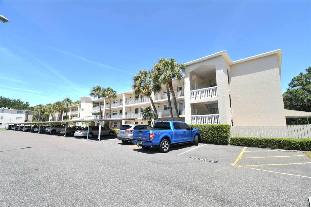 936 Virginia Street, Unit 206 Dunedin, FL 34698 - Photo 3 of 22 a car parked in front of a building