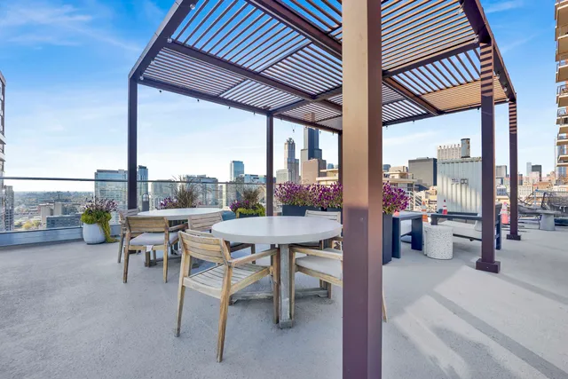a balcony with chairs and a table