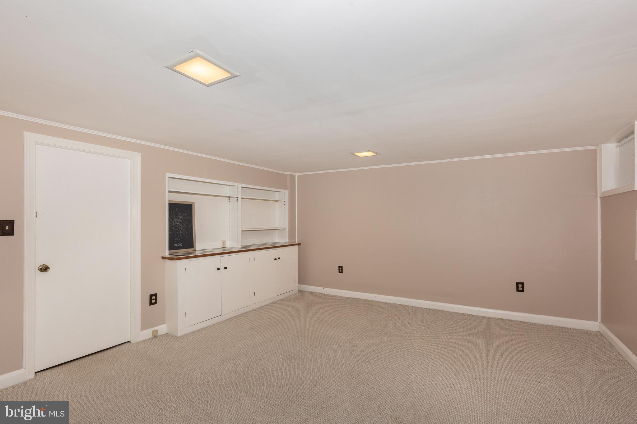 202 Brandon Road Baltimore, MD 21212 - Photo 29 of 42 a view of an empty room with window and wooden floor