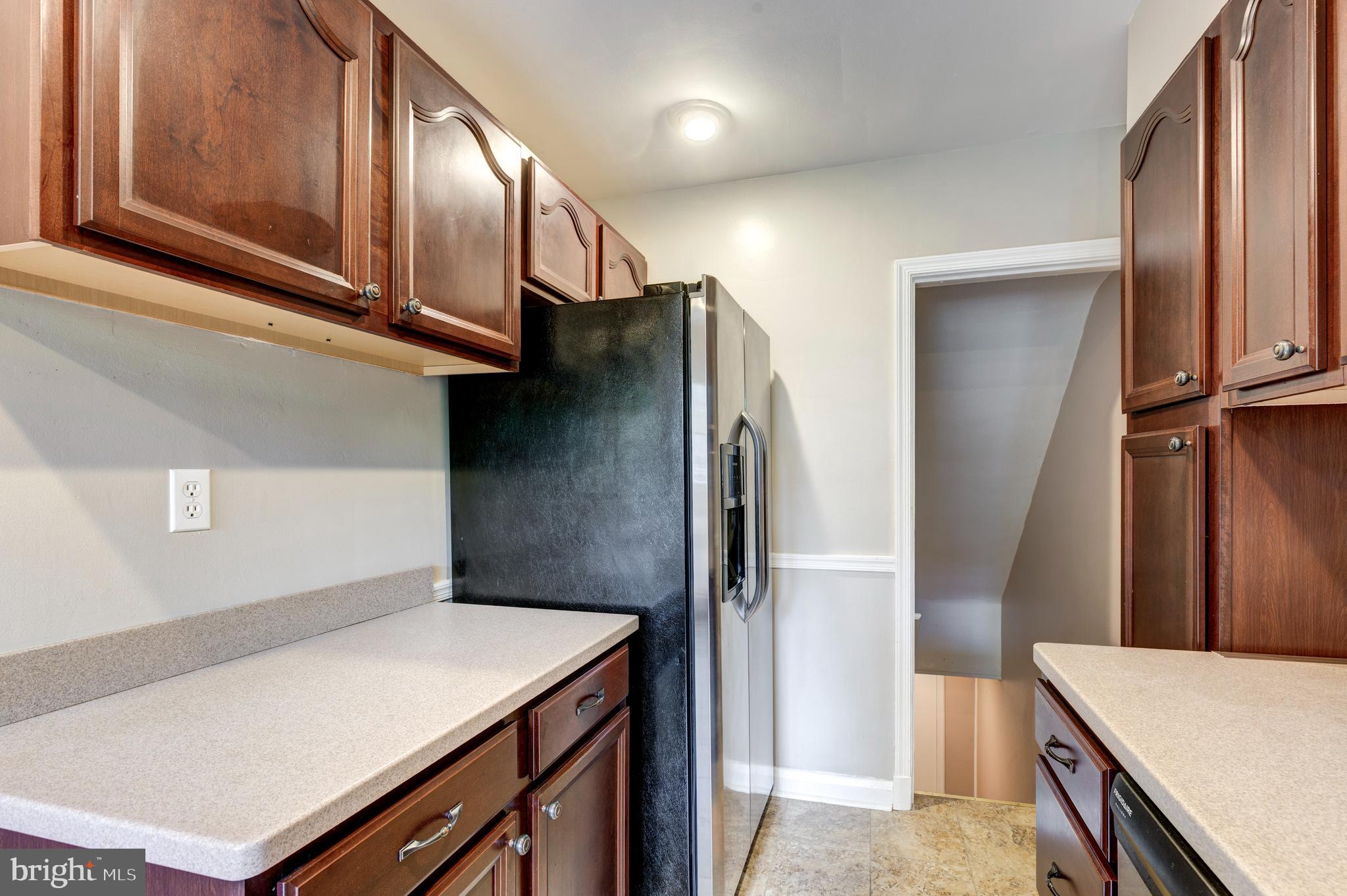 202 Brandon Road Baltimore, MD 21212 - Photo 8 of 42 a kitchen with stainless steel appliances a refrigerator and a stove