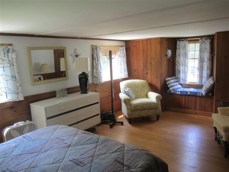 17 Scraggy Neck Road Cataumet, MA 02534 - Photo 18 of 29 a bedroom with furniture and a window