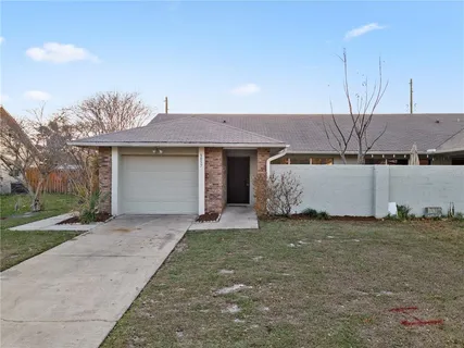 a front view of a house with a garden and yard