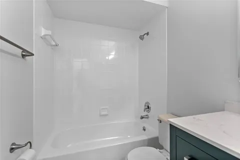 a bath room with a toilet and a bath tub