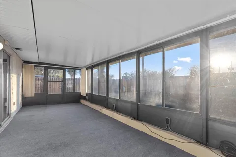 a view of an empty room with windows