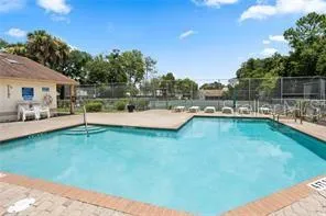 a backyard of a house with table and chairs