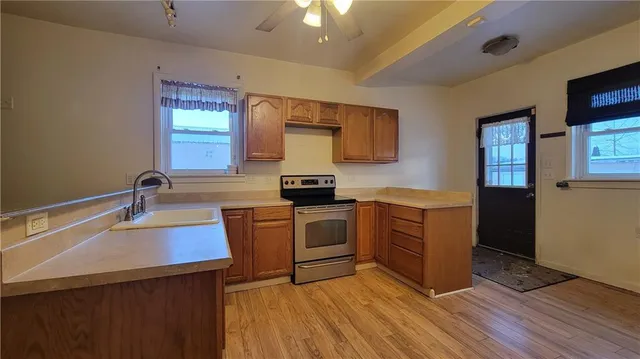a kitchen with a sink appliances and cabinets