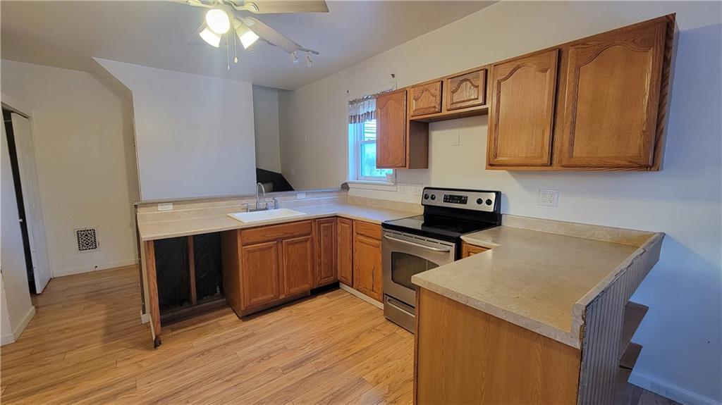 342 East Main Street Somerset, PA 15501 - Photo 12 of 43 a kitchen with a sink a microwave a stove and refrigerator