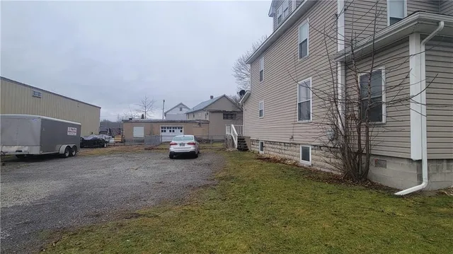 a view of a house with a truck parked in a yard
