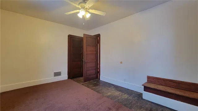 an empty room with a empty space and a ceiling fan