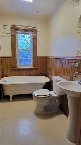 a bathroom with a sink a toilet and bathtub