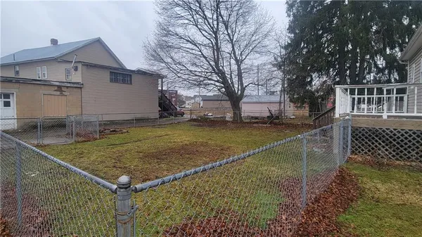 a view of a backyard with a fence