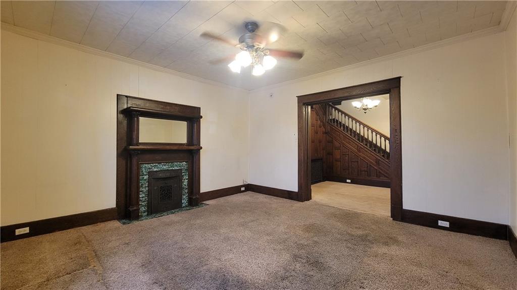 342 East Main Street Somerset, PA 15501 - Photo 9 of 43 a view of an empty room with a fireplace and a ceiling fan