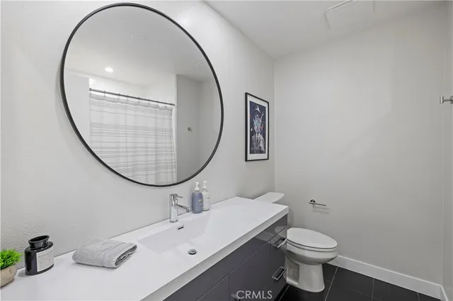 a bathroom with a sink mirror and toilet