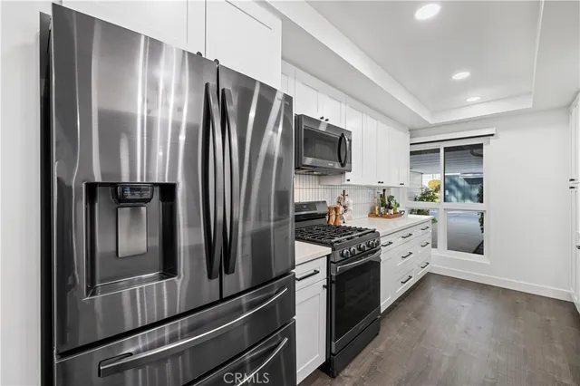 a kitchen with stainless steel appliances a refrigerator sink and stove